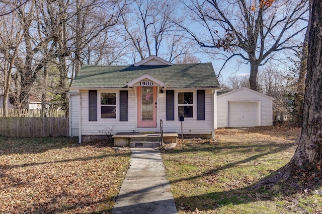 bungalow-style house featuring a garage, an outdoor structure, and a front yard