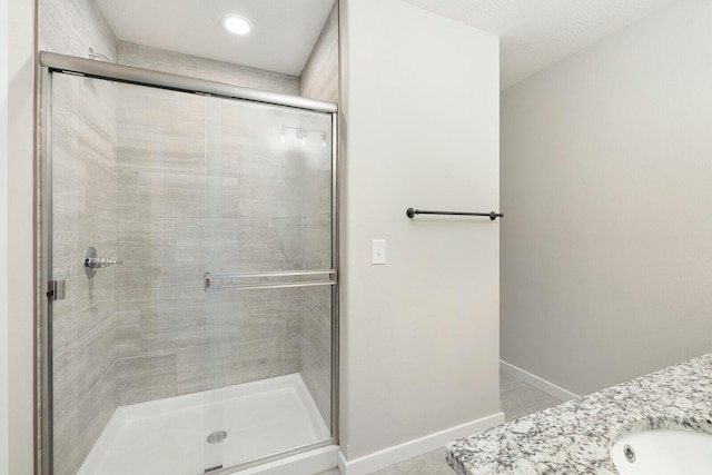 bathroom with vanity and a shower with shower door