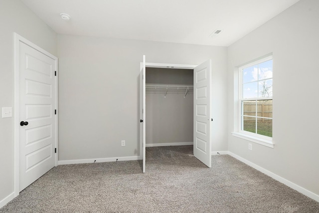 unfurnished bedroom featuring carpet flooring and a closet