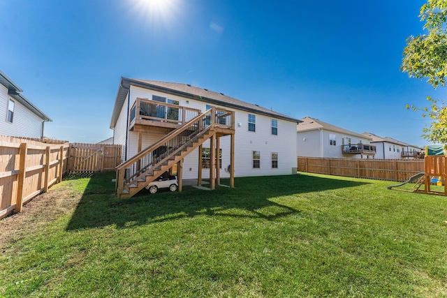 back of property featuring a playground and a lawn