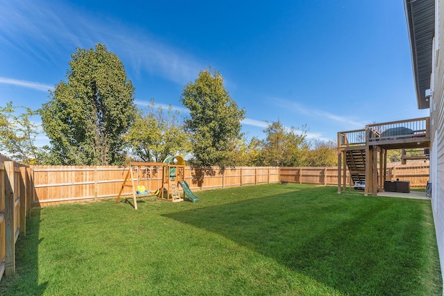 view of yard featuring a deck and a playground