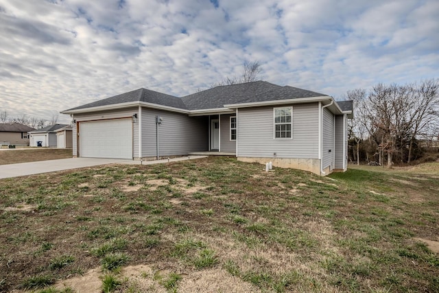 single story home featuring a garage and a front yard