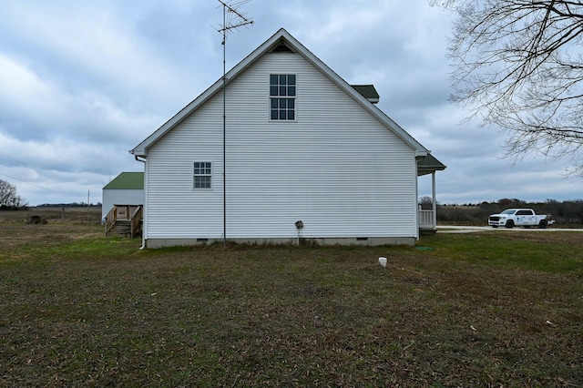 view of side of home with a lawn