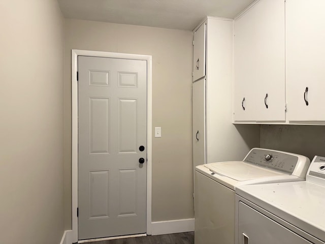 clothes washing area with cabinets, dark hardwood / wood-style floors, and independent washer and dryer