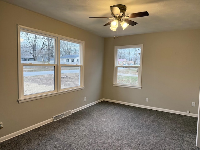 carpeted empty room featuring ceiling fan