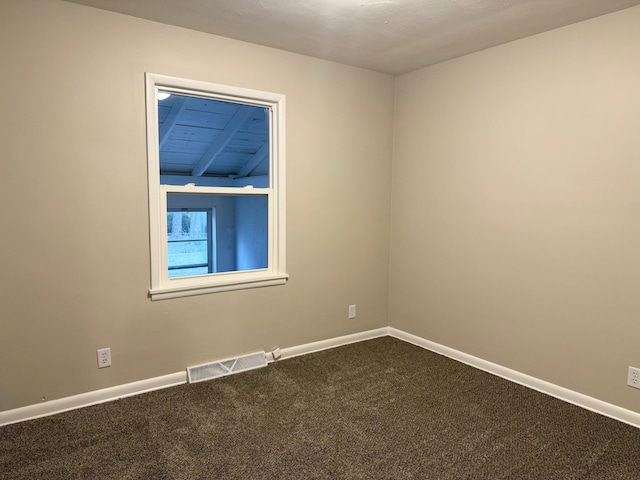 empty room with carpet flooring and lofted ceiling