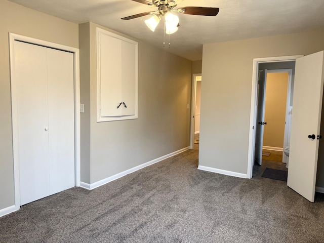 unfurnished bedroom featuring ceiling fan, dark carpet, and a closet