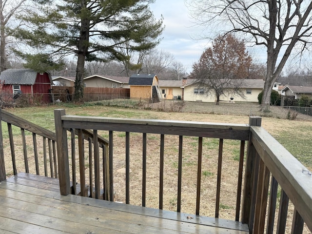 wooden terrace featuring a yard