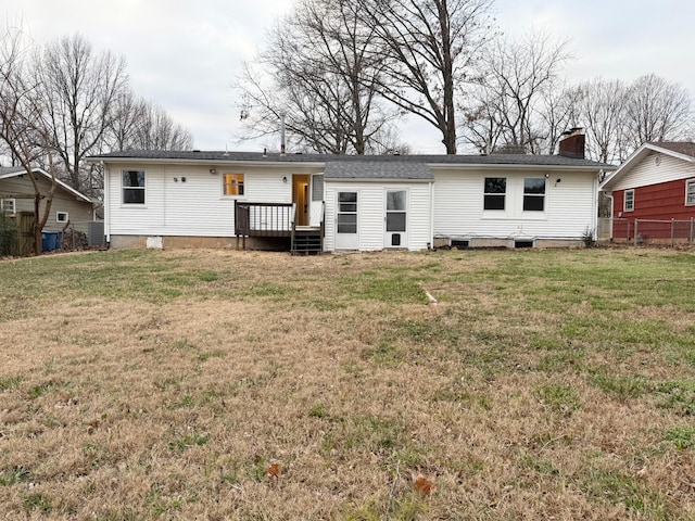 back of house featuring a yard and a deck