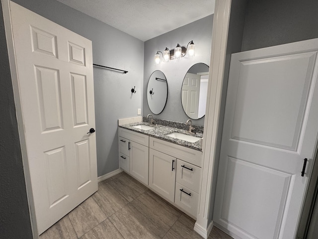 bathroom with vanity and a textured ceiling