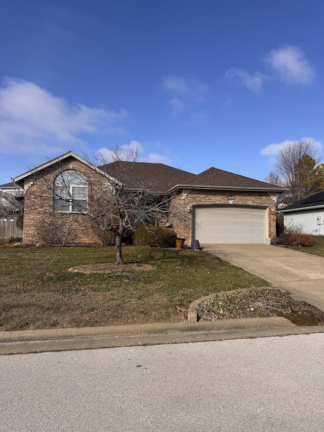 single story home with a garage and a front yard