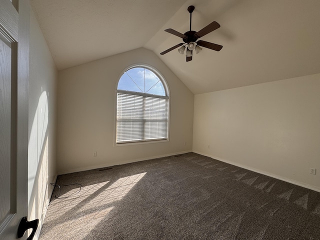 carpeted empty room featuring ceiling fan and lofted ceiling