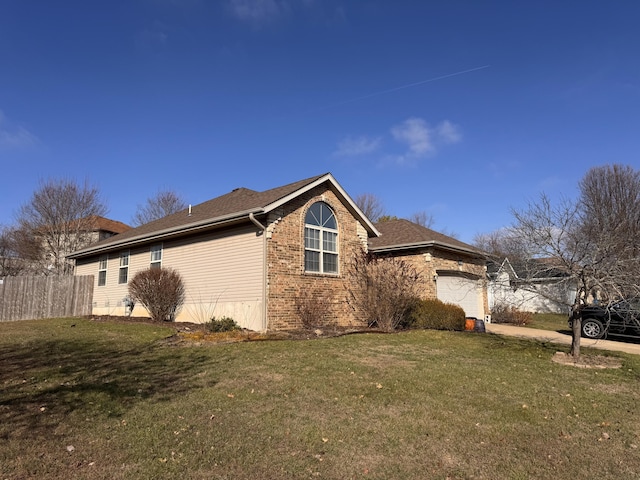 view of side of property with a yard and a garage