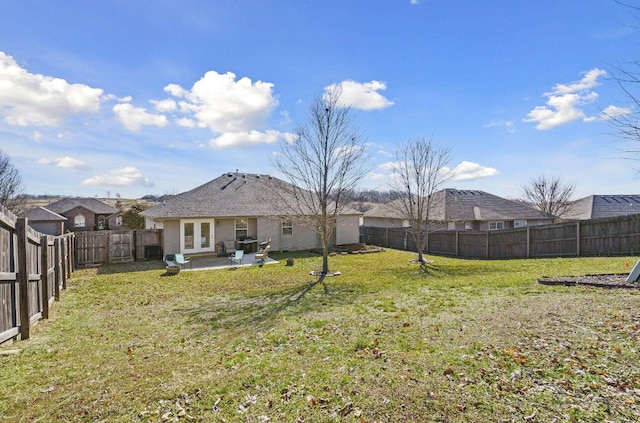 back of property with a lawn, a patio, and french doors