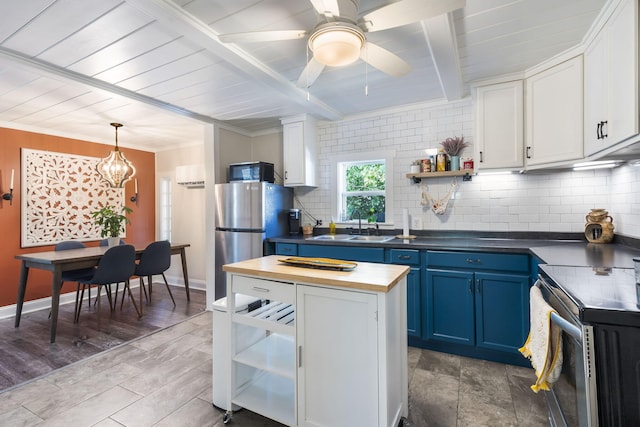 kitchen with sink, blue cabinets, pendant lighting, white cabinets, and range