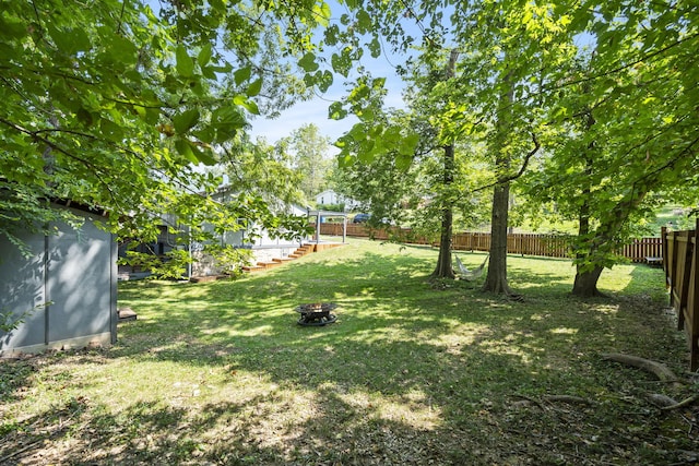 view of yard with a fire pit