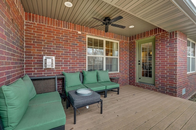 wooden terrace featuring outdoor lounge area and ceiling fan