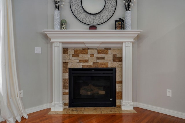 interior details featuring a fireplace and hardwood / wood-style flooring