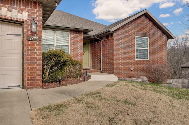 entrance to property with a yard and a garage