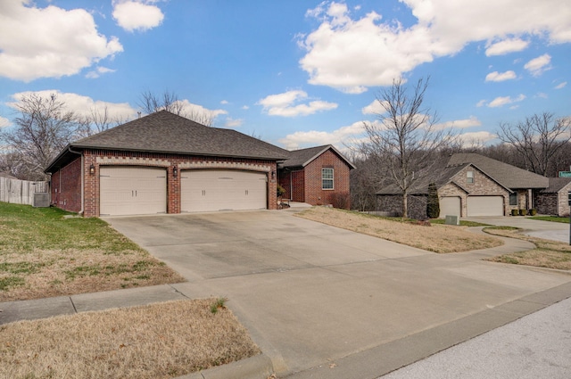 ranch-style house featuring a front yard and a garage