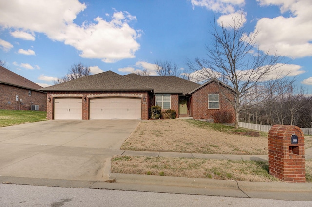 view of front of home with central AC and a garage