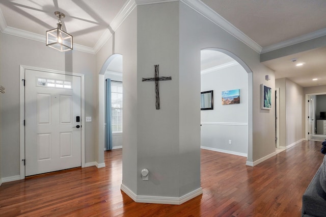 foyer entrance with dark hardwood / wood-style flooring and crown molding