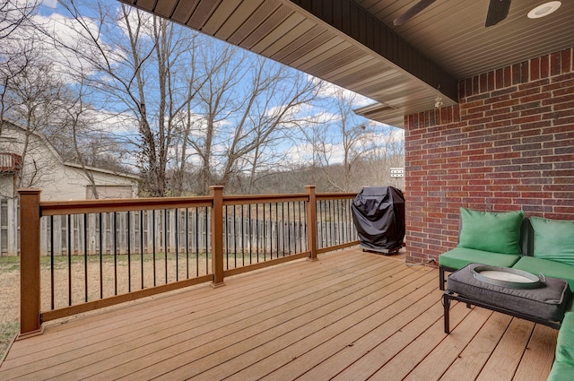 deck featuring ceiling fan and a grill