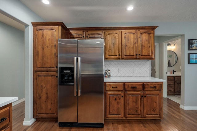 kitchen featuring backsplash, stainless steel fridge with ice dispenser, and dark hardwood / wood-style flooring