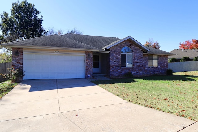 ranch-style house with a front lawn and a garage