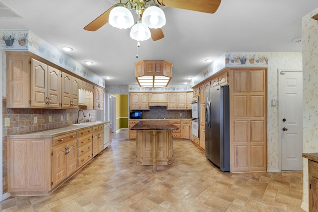 kitchen featuring light brown cabinetry, decorative backsplash, a center island, and white appliances