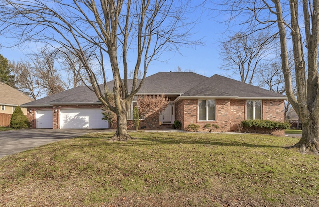 single story home featuring a front yard and a garage