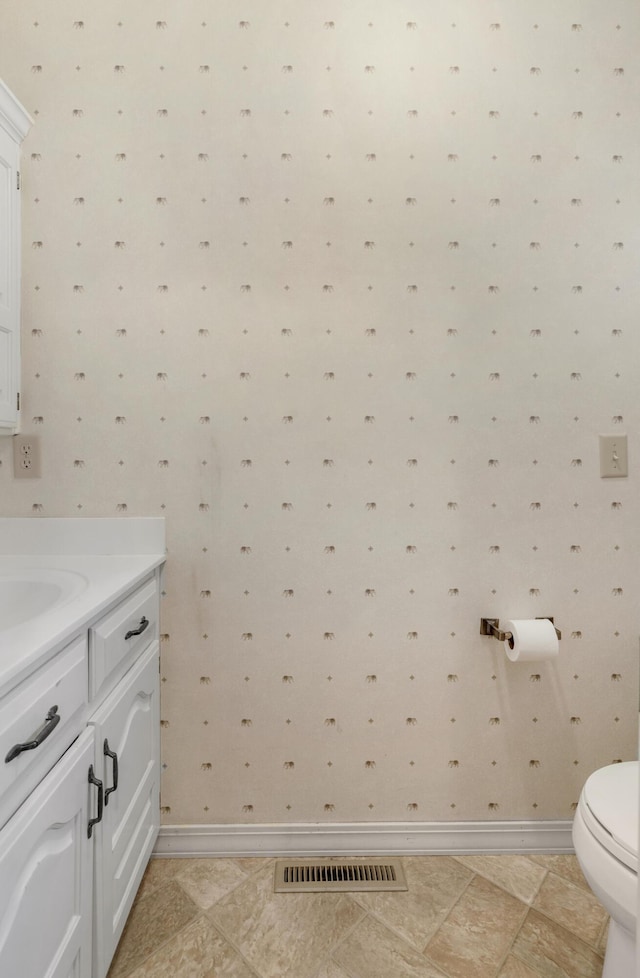 bathroom with tile patterned floors, vanity, and toilet