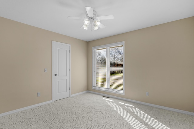 empty room with carpet flooring and ceiling fan