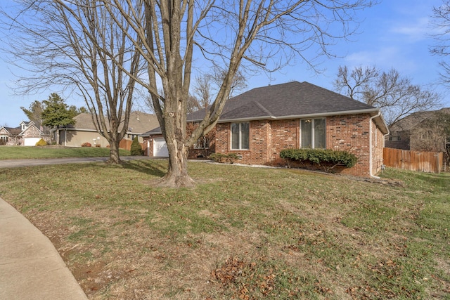 ranch-style home with a front yard and a garage