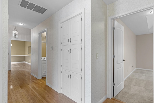 corridor with light wood-type flooring