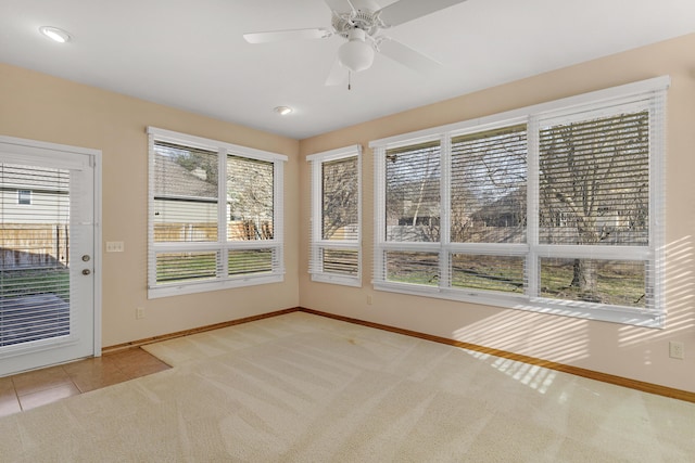 unfurnished sunroom featuring ceiling fan