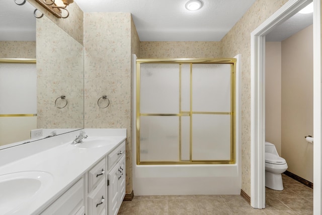 full bathroom with a textured ceiling, vanity, enclosed tub / shower combo, tile patterned flooring, and toilet