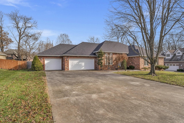 view of front of house with a garage and a front lawn