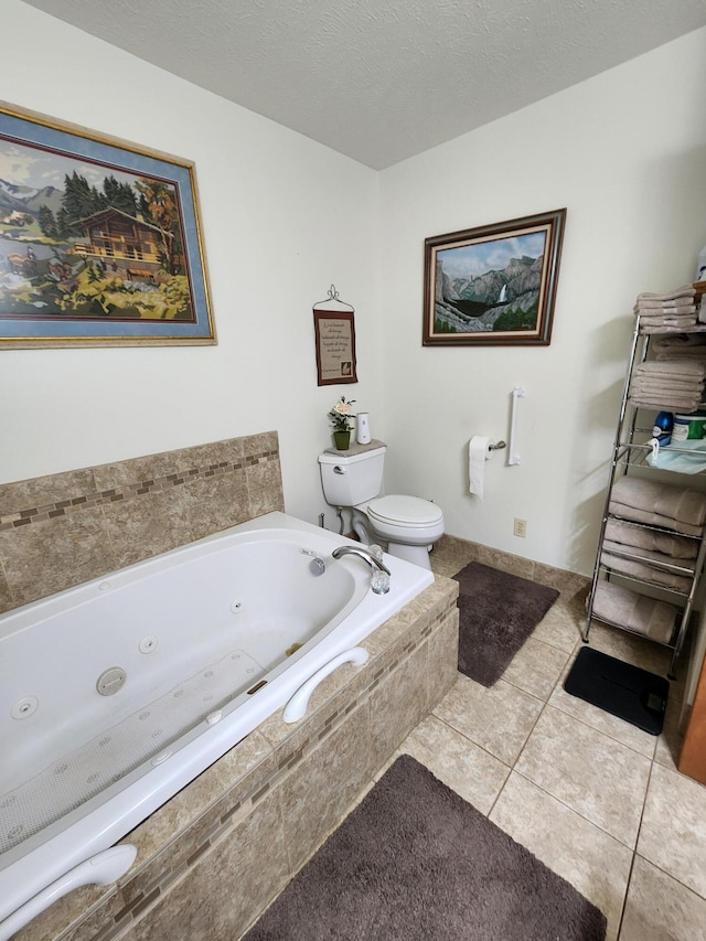 bathroom featuring tile patterned flooring, a textured ceiling, a relaxing tiled tub, and toilet