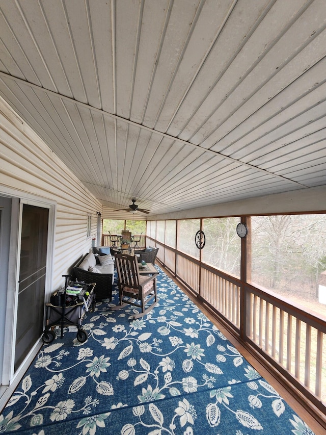 sunroom / solarium with ceiling fan and wooden ceiling