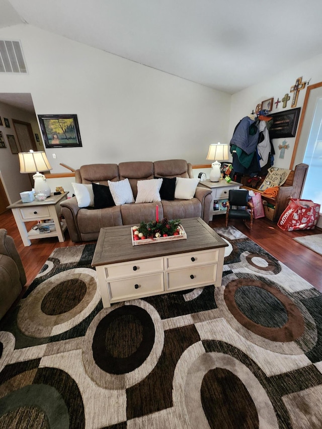 living room with dark hardwood / wood-style floors and lofted ceiling