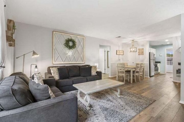 living room with a chandelier and wood-type flooring