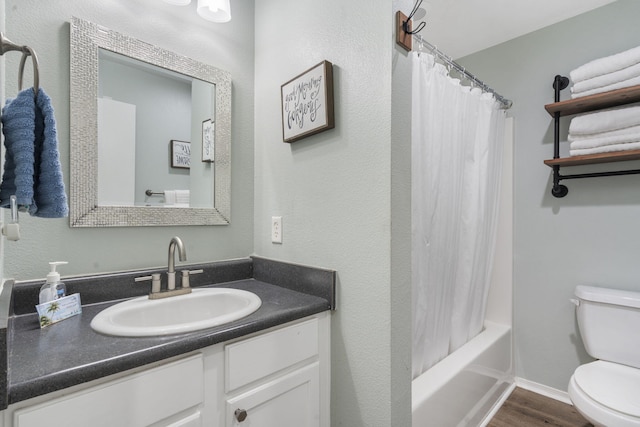 full bathroom with hardwood / wood-style floors, vanity, toilet, and shower / tub combo with curtain