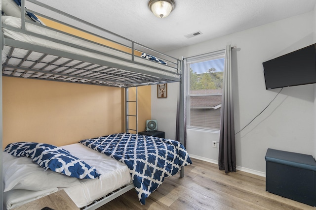 bedroom with wood-type flooring