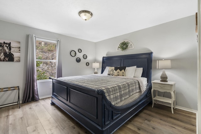 bedroom with hardwood / wood-style flooring