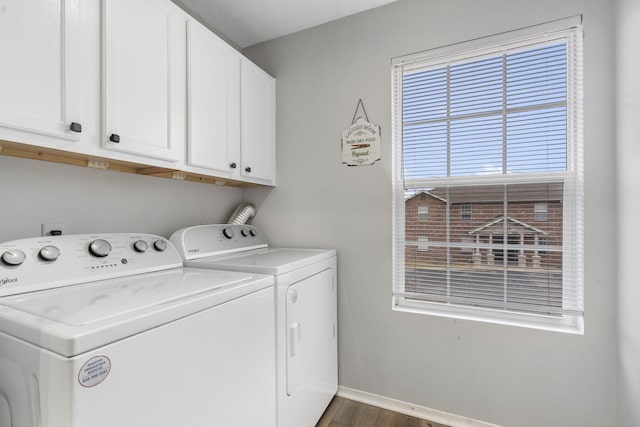 clothes washing area featuring cabinets, separate washer and dryer, and dark wood-type flooring