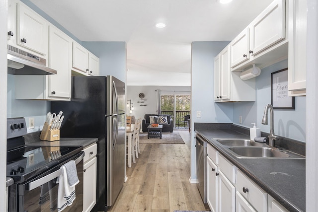 kitchen with sink, black electric range, stainless steel dishwasher, light wood-type flooring, and white cabinetry