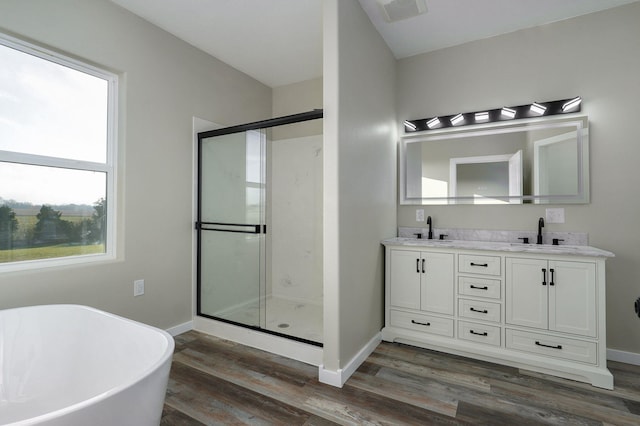 bathroom featuring separate shower and tub, wood-type flooring, and a wealth of natural light