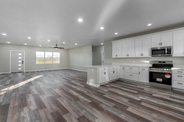 kitchen featuring kitchen peninsula, white cabinets, and appliances with stainless steel finishes