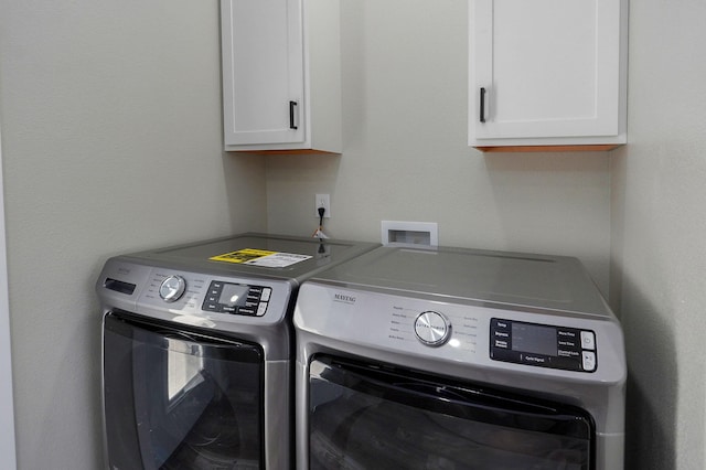 laundry area featuring cabinets and separate washer and dryer